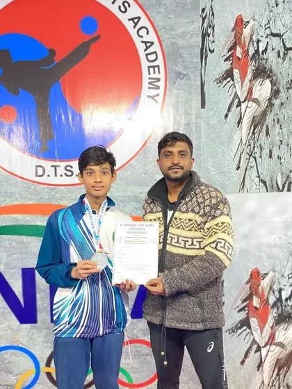 This student proudly holds his certificate and medal after competing in the National Sikh Games. His dedication in class paid off.