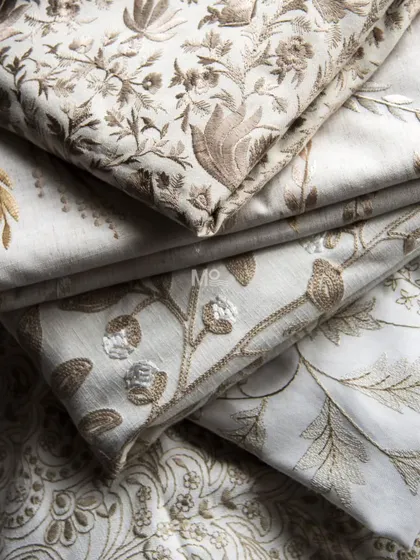 Inspired by European classical interiors, this bespoke curtain fabric features meticulously embroidered botanical motifs on a neutral base, echoing the charm of traditional French floral tapestries.