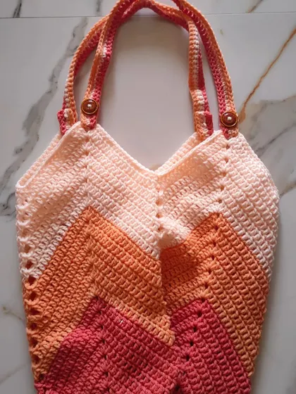 I designed this Chevron Tulip Bag to be the perfect carry-all for my crochet projects. The sturdy chevron stitch gives it a lovely shape and texture, and it’s spacious enough to hold plenty of yarn and tools for crafting on the go.