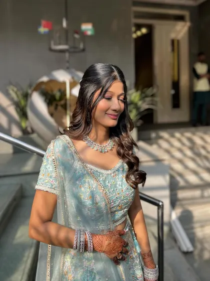 The bride-to-be enjoying the sunlight, which beautifully highlights her radiant and dewy makeup.