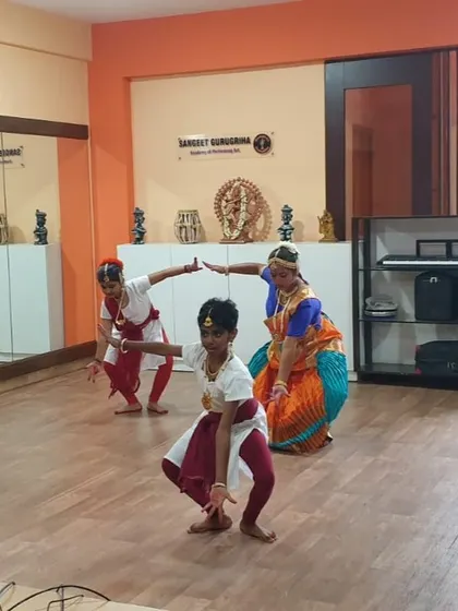 Students in a Bharatanatyam class, holding a pose that requires balance and strength, key elements of this traditional dance form.