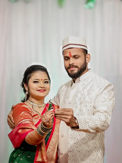The couple posing together, showing their rings after the engagement ceremony.