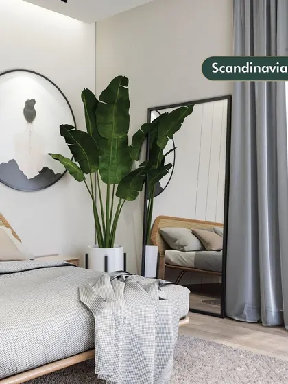 An example of our Scandinavian style, this bedroom corner is clean, bright, and calming. The use of neutral colors, natural wood, a large plant, and a full-length mirror makes the space feel open and serene.