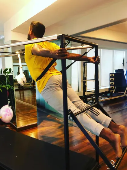 More stretching, less stressing. Using the Cadillac for a deep back and shoulder stretch, which is essential for mobility and posture.
