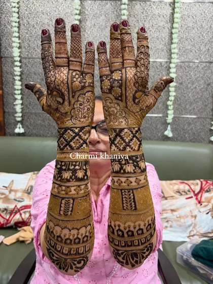 A close up of the intricate patterns on this heavy, traditional back of hand design for the groom's mom.