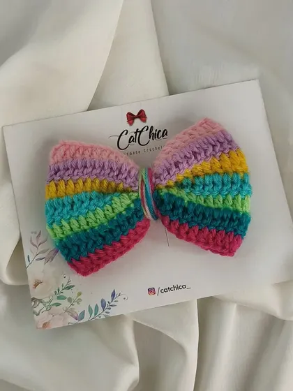 Our pastel rainbow sailor bow, a softer take on the classic rainbow design.