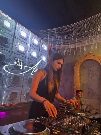 A focused shot of me mixing at a wedding event with a futuristic, space-themed LED wall. This demonstrates the high-tech visual production I can incorporate into my events.