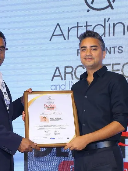 Vijay receiving a certificate of appreciation for his participation in the design debate.