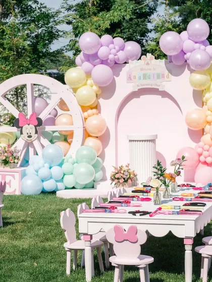 The kids' activity table, ready with coloring supplies, set against the beautiful pastel backdrop.