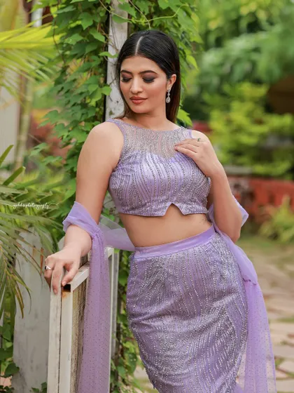 A designer shoot for a modern lavender lehenga. The images were taken in a lush garden, with the purple flowers complementing the color of the outfit, creating a soft and romantic fashion story.