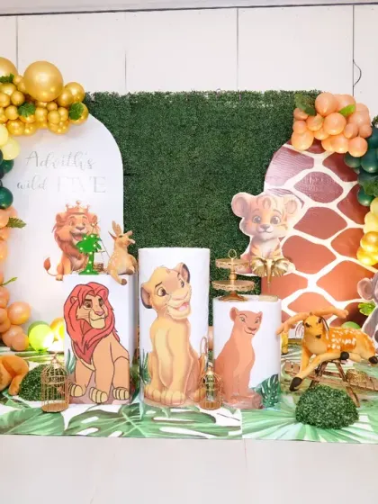 A grand Lion King theme for Advik's "Wild Five" birthday party. We used multiple backdrops with greenery and giraffe print, character cutouts, and a beautiful balloon garland to create a rich and detailed jungle scene.