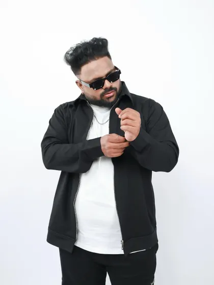 Adjusting my cuff in a stylish studio photo. It's all about the details, both in my music and in my presentation as an artist.