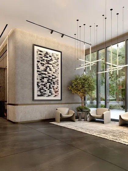 A wider view of the commercial tower's lounge, where glass walls dissolve the boundary between exterior and interior. Natural light glides across surfaces, highlighting the curated art and bespoke lighting installations.