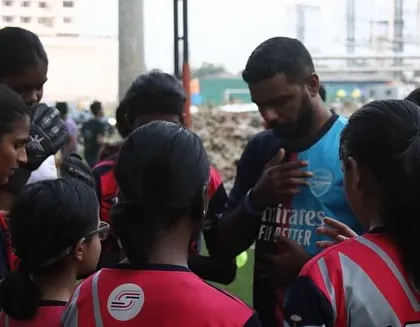 A coach in a huddle with the girls' team, providing motivation and strategy. This is where games are won and lessons are learned.