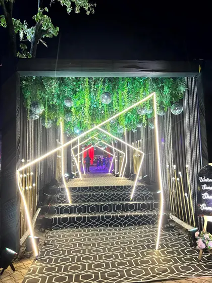 Your guests' first impression matters. We crafted this futuristic Sangeet entrance tunnel using geometric neon lights, hanging disco balls, and a dramatic patterned walkway to build excitement from the moment they arrived.