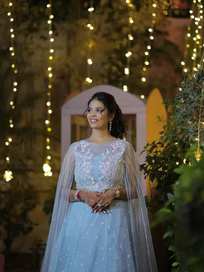 Looking like she stepped right out of a fairytale for her sangeet. The powder blue lehenga with a cape is paired with a curly ponytail and glowing makeup.