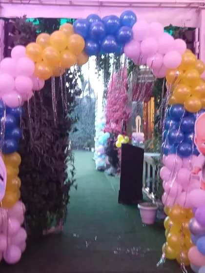 An entrance arch for an outdoor party area. This one combines a Frozen theme on one side and a Boss Baby theme on the other, using different color schemes to match each character.