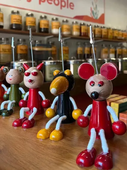 A lineup of our 'Tunti Tuntas' note holders, ready to bring character to any office. These handcrafted wooden figures are a fun and practical way to organize notes and photos.