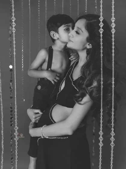 The joy and love between a mother and her first child are beautifully captured in this black and white family maternity photo.