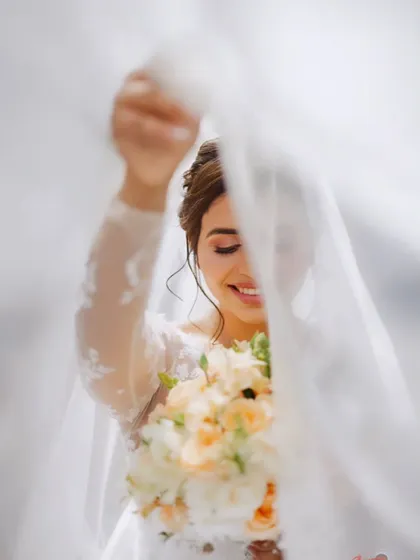 Looking like an absolute dream. The way the veil catches the light here is just magical, highlighting her radiant smile and the soft, romantic makeup I created for her.