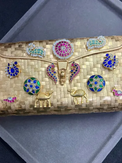 A top-down view of our silver fusion clutch with gold plating. This image highlights the basket-weave texture and the vibrant, hand-placed traditional motifs that make each bag unique.