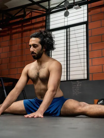 Taking a moment to breathe and stretch. This middle split is a result of years of consistent mobility work. It's a reminder to be kind to your body and celebrate your progress, no matter how small.