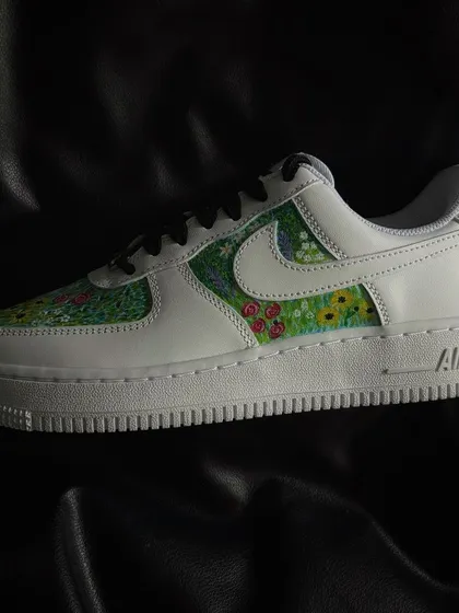 A custom Nike Air Force 1 featuring a vibrant, pointillism-style flower field design.