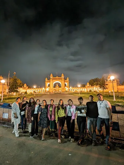 Our group visiting the beautifully lit Mysore Palace at night during our Wayanad trip.
