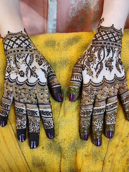 A beautiful design with a mix of net patterns and leafy vines. The purple nails provide a fun pop of color.