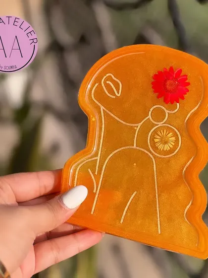 This bright orange trinket tray is full of energy. It's a functional piece of art that can brighten up any space.