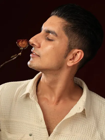 A serene profile shot with the model smelling a dried rose. This image conveys a softer, more poetic emotion, adding range to a portfolio.