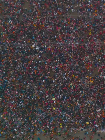 A direct top-down shot of the devotees during the Shahi Snan. This perspective highlights the sheer density of the crowd, a powerful visual of collective faith.