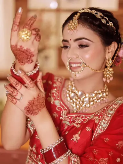 A happy bride shows off her simple yet elegant henna design and wedding ring.