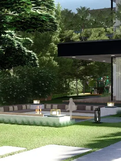 A perspective of a sunken seating area from the lawn, showing its integration with the main house and surrounding trees. The design uses changes in level to create dynamic and interesting garden layouts.