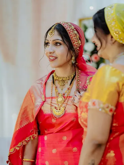 A candid shot of the bride, her smile radiant. Her makeup looks natural and enhances her features.