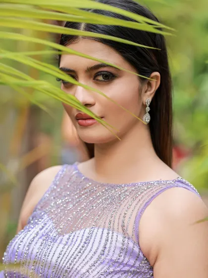 A designer shoot for a modern lavender lehenga. The images were taken in a lush garden, with the purple flowers complementing the color of the outfit, creating a soft and romantic fashion story.