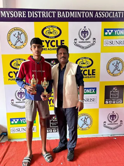 Sankeerth with his bronze medals in U-17 singles and doubles at the state ranking tournament in Mysore. Pictured here with a tournament official.