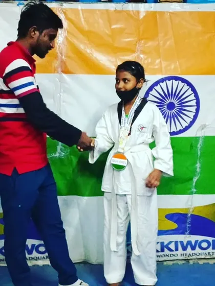 A handshake to congratulate my student on her victory.