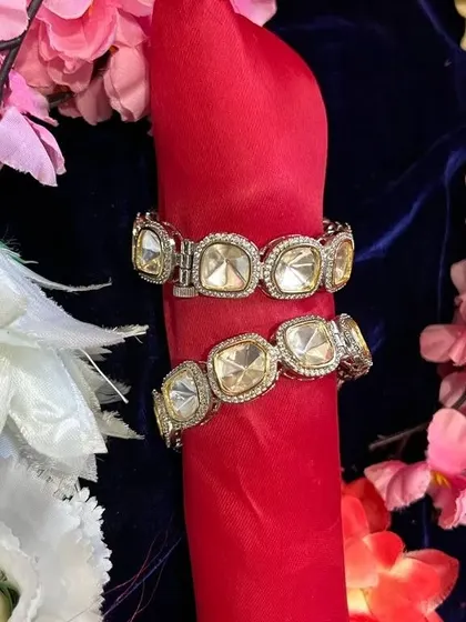 A pair of statement Polki and AD bangles. These bold pieces are perfect for adding some sparkle to your wrist for a party or festive event.