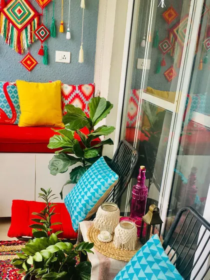 My tiny balcony in different looks. This one has a bohemian, colorful vibe with bright cushions and wall hangings.