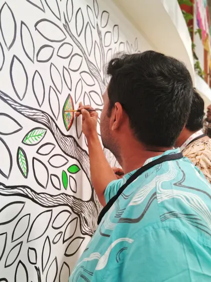 Another artist contributing to the 'Mosaic of Us' mural. The process of painting together is just as beautiful as the final result.