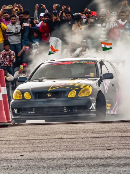 Another angle of the Lexus drift car, engulfed in smoke in front of a massive audience. This is the kind of high-impact visual that defines our events.