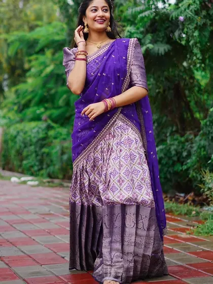 The rich purple color and intricate print of this Langa Davani make it a regal choice for any special occasion.