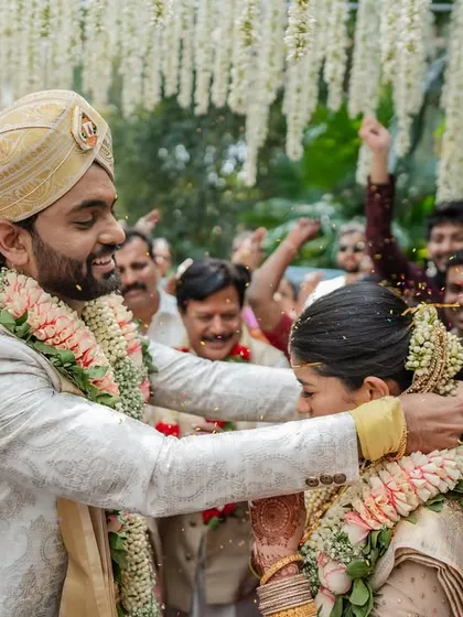 A beautiful moment during the wedding ceremony, with guests showering the couple with blessings and petals. We capture the collective joy of everyone involved.
