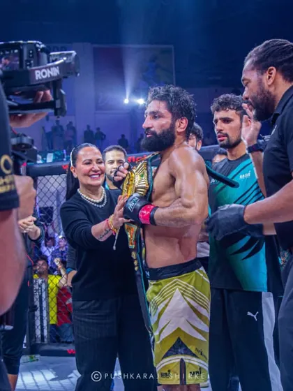 A champion surrounded by his team after a win. Victory is a collective effort.