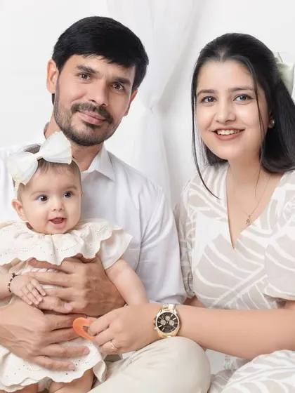 A beautiful, classic family portrait with everyone looking happy and relaxed.