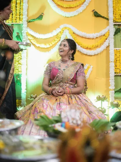 A candid moment of joy from the Bhale Shastra ceremony, with the bride-to-be looking radiant in her traditional attire and jewellery.
