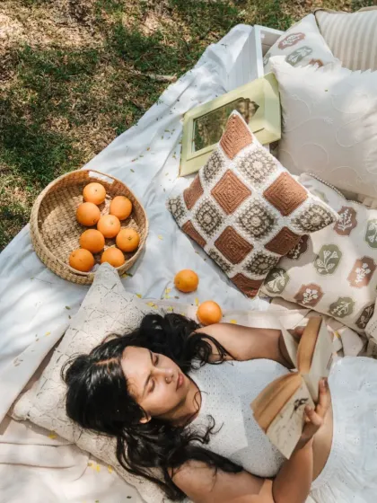 A lazy afternoon spent reading, surrounded by our 'Woodland Whispers' collection. The cushions feature delicate floral stamps, crochet details, and muted geometric prints for a timeless, charming look.