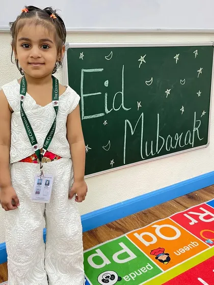 A student poses happily by our Eid Mubarak board. The classroom was filled with a spirit of joy, sharing, and cultural learning.