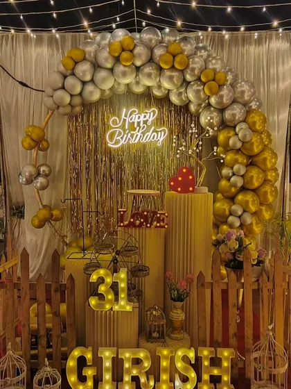 Don't have a large venue? No problem. We can transform any space, like this terrace, into a beautiful party spot with a canopy of fairy lights, a stylish balloon arch, and a personalized backdrop for a memorable birthday surprise.